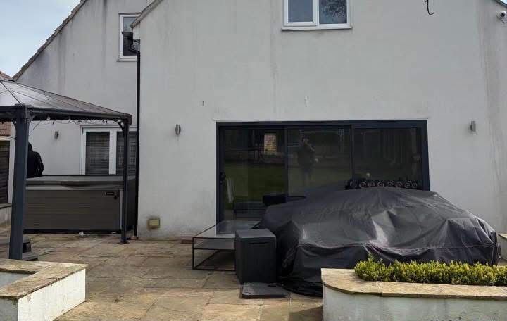 Rear elevation of a detached rendered house before cleaning